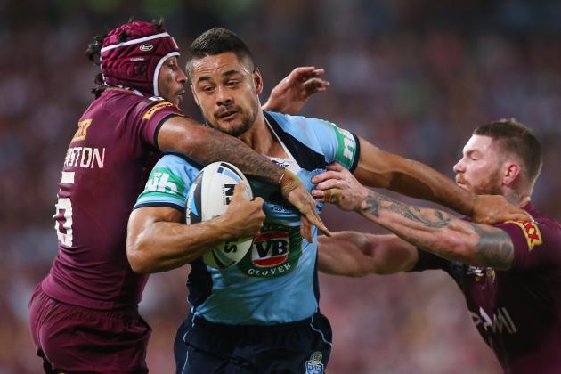 BRISBANE, AUSTRALIA - MAY 28:  Jarryd Hayne of the Blues breaks through the defence of Johnathan Thurston and Chris McQueen of the Maroons to score a try during game one of the State of Origin series between the Queensland Maroons and the New South Wales Blues at Suncorp Stadium on May 28, 2014 in Brisbane, Australia.  (Photo by Chris Hyde/Getty Images)