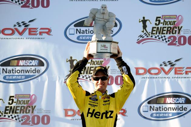 DOVER, DE - SEPTEMBER 28: Joey Logano, driver of the #22 Hertz Ford, poses with the 'Miles the Monster' trophy after winning the NASCAR Nationwide Series 5-Hour Energy 200 Benefiting Living Beyond Breast Cancer at Dover International Speedway on September 28, 2013 in Dover, Delaware. (Photo by Jared C. Tilton/Getty Images)