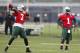 New York Jets quarterback Geno Smith, left, throws a pass while quarterback Michael Vick looks on during an NFL football organized team activity, Wednesday, May 28, 2014, in Florham Park, N.J. (AP Photo/Julio Cortez)