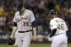 Detroit Tigers pitcher Joe Nathan (36) walks off the field past Oakland Athletics first base coach Tye Waller (46) after allowing a three-run home run to Josh Donaldson during the ninth inning of a baseball game in Oakland, Calif., Wednesday, May 28, 2014. The Athletics won 3-1. (AP Photo/Jeff Chiu)