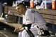 Miami Marlins starting pitcher Jose Fernandez watches from the dugout during the ninth inning of a baseball game against the Atlanta Braves, Tuesday, April 29, 2014, in Miami. The Marlins defeated the Braves 9-0. (AP Photo)