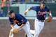 Virginia's Nick Howard (33) makes a catch in front of teammate Kenny Towns (9) during the third inning of an NCAA college baseball tournament regional game against Elon in Charlottesville, Va., Saturday, June 1, 2013. (AP Photo/Andrew Shurtleff)