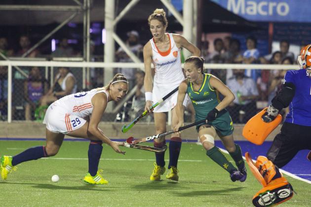 Netherlands' Jacky Schoenaker, left, challenges Australia's Emily Smith, right, during the women's field hockey World League final game, in San Miguel de Tucuman, Argentina, Sunday, Dec. 8, 2013. (AP Photo/Paloma Cortes Ayusa)