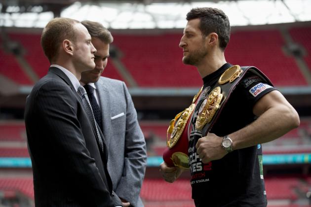 IBF and WBA super-middleweight boxing champion Carl Froch, right, poses for photographers in a head-to-head with his opponent George Groves, left, and British boxing promoter Eddie Hearn at Wembley Stadium in London, Thursday, May 29, 2014.  Billed as one of the biggest fights in British boxing history, the second installment of Carl Froch vs. George Groves has the ingredients of a classic. Saturday's fight for Froch's IBF and WBA super-middleweight titles will take place at Wembley Stadium in front of a record British boxing crowd of about 80,000 fans.  (AP Photo/Matt Dunham)