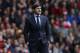 FILE - In this Sunday, May 11, 2014, file photo, Southampton's manager Mauricio Pochettino watches his team play against Manchester United during their English Premier League soccer match at St Mary's stadium, Southampton, England. Tottenham has hired Mauricio Pochettino as the club's new manager on a five-year contract, with the former Argentina defender making the move from fellow Premier League side Southampton. (AP Photo/Sang Tan, File)