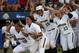 Baylor players react after Ari Hawkins hit a home run during an NCAA Women's College World Series softball tournament game against Kentucky in Oklahoma City, Saturday, May 31, 2014. (AP Photo/Garett Fisbeck)