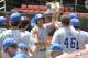 Kentucky's Matt Reida, center, is congratulated by teammates after scoring in the fourth inning during an NCAA college baseball regional tournament game against Kansas in Louisville, Ky., Sunday, June 1, 2014. (AP Photo/Timothy D. Easley)