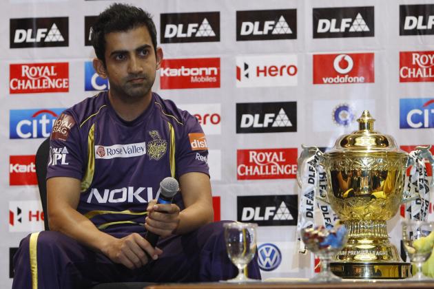 Kolkata Knight Riders captain Gautam Gambhir sits next to the winning trophy of the Indian Premier League (IPL) during a photo call on the eve of the final match against Chennai Super Kings, in Chennai, India, Saturday, May 26, 2012. (AP Photo/Aijaz Rahi)