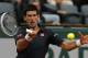 Serbia's Novak Djokovic returns the ball to Canada's Milos Raonic during their quarterfinal match of the French Open tennis tournament at the Roland Garros stadium, in Paris, France, Tuesday, June 3, 2014. Djokovic won 7-5, 7-6, 6-4. (AP Photo/Michel Spingler)