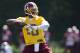 Washington Redskins quarterback Robert Griffin III throws a pass during an NFL football practice at Redskins Park, on Wednesday, June 4, 2014, in Ashburn, Va. (AP Photo/ Evan Vucci)