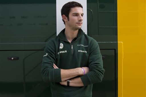 In this June 29, 2013 photo, American Caterham driver Alexander Rossi poses at the Silverstone circuit in Silverstone, England. As Formula One expands its reach into the United States, there remains one missing ingredient that could keep some fans away from the grand stands _ an American driver on the grid.(AP Photo/Jon Super)
