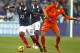 France's Eliaquim Mangala, left, vies for the ball with Netherlands' Robin Van Persie, right, during the friendly soccer match between France and Netherlands at the Stade de France in Saint Denis, north of Paris, Wednesday March 5, 2014. France won 2-0.France's Paul Pogba watches at center.(AP Photo/Remy de la Mauviniere)
