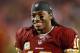 FILE - In this Nov. 25, 2013 file photo, Washington Redskins quarterback Robert Griffin III smiles as he walks along the sidelines before an NFL football game against the San Francisco 49ers in Landover, Md. Griffin III will drive the pace car before Saturday night's, April 26, 2014 NASCAR race at Richmond. Richmond International Raceway made the announcement Wednesday, April 23, 2014. (AP Photo/Evan Vucci, File)