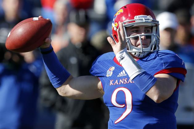 Kansas quarterback Jake Heaps (9) passes to a teammate during the first half of an NCAA college football game against Kansas State in Lawrence, Kan., Saturday, Nov. 30, 2013. (AP Photo/Orlin Wagner)