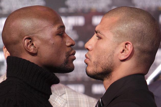 Boxers Floyd Mayweather, left, and Miguel Cotto face-off during a news conference in New York, Tuesday, Feb. 28, 2012. Cotto and Mayweather will fight in Las Vegas  on May 5, 2012 for Cotto's WBA World super welterweight title.. (AP Photo/Seth Wenig)
