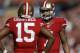 San Francisco 49ers wide receiver Michael Crabtree (15) talks with quarterback Colin Kaepernick before an NFL football game against the St. Louis Rams in San Francisco, Sunday, Dec. 1, 2013. (AP Photo/Marcio Jose Sanchez)