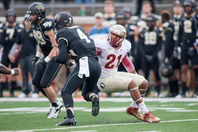Nov 9, 2013; Winston-Salem, NC, USA; Florida State Seminoles defensive end Chris Casher (21) pursues Wake Forest Demon Deacons quarterback Tyler Cameron (4) during the third quarter at BB&T Field. Florida State defeated Wake Forest 59-3. Mandatory Credit: Jeremy Brevard-USA TODAY Sports