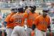 Houston Astros' Jon Singleton (28) is congratulated by teammates George Springer, left, Dexter Fowler and Jonathan Villar, right, after Singleton's grand slam off Minnesota Twins relief pitcher Glen Perkins during the ninth inning of a baseball game in Minneapolis, Sunday, June 8, 2014. The Astros won 14-5. (AP Photo/Ann Heisenfelt)