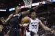 San Antonio Spurs forward Boris Diaw (33) passes around Miami Heat center Chris Bosh (1) during the second half in Game 2 of the NBA basketball finals on Sunday, June 8, 2014, in San Antonio. (AP Photo/Eric Gay)