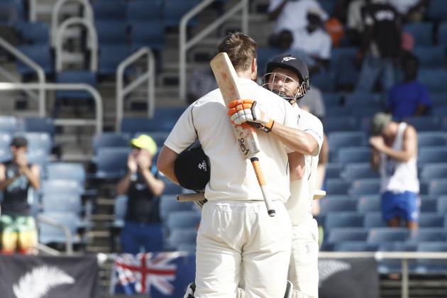 New Zealand's batsman Jimmy Neesham, left, back to camera is congratulated by his batting partner BJ Watling after scoring a century against West Indies during the second day of their first cricket Test match in Kingston, Jamaica, Monday, June 9, 2014. (AP Photo/Arnulfo Franco)