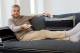 Man with TV remote (Photo by: Cultura /AP Images)