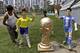 Indian artist Sukumar Rudra Pal gives finishing touches to clay models of Brazil and Argentina soccer players beside a clay replica of soccer World Cup as they are made ready for display at a club in Kolkata, India, Tuesday, June 10, 2014. Soccer fans around the world are gearing up to watch the World Cup soccer tournament that kicks off Thursday in Brazil. (AP Photo/ Bikas Das)