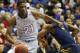 Kansas center Joel Embiid (21) pushes off West Virginia forward Devin Williams, right, during the first half of an NCAA college basketball game in Lawrence, Kan., Saturday, Feb. 8, 2014. Embiid scored 11 points in the game. Kansas defeated West Virginia 83-69. (AP Photo/Orlin Wagner)