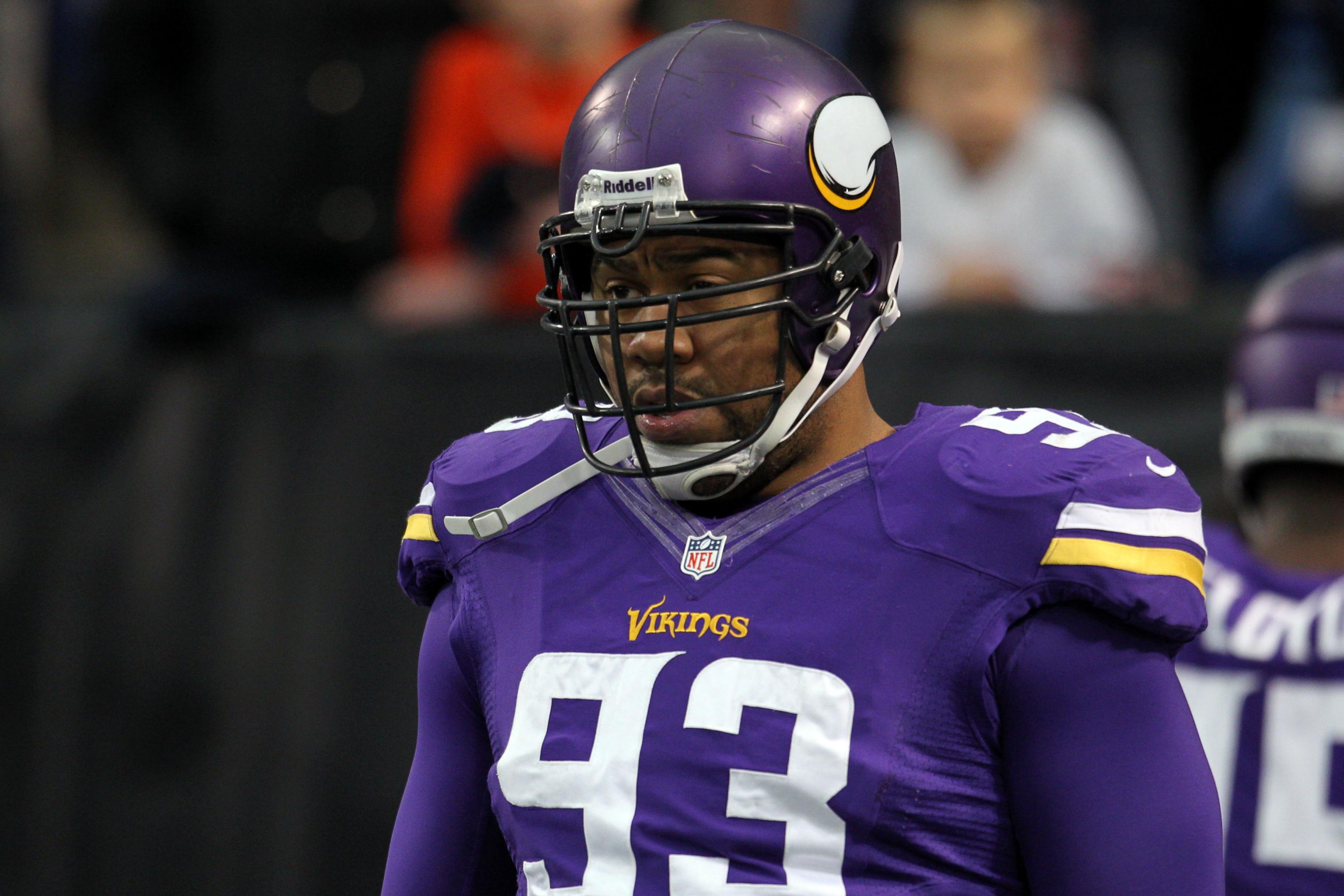 Minnesota Vikings defensive tackle Pat Williams looks at a replay