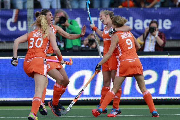 Teammates hug Netherlands' Xan de Waard, second right, after she scored 1-0 during the Field Hockey World Cup semifinal match women between the Netherlands and Argentina in The Hague, Netherlands, Thursday, June 12, 2014. (AP Photo/Peter Dejong)