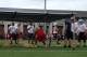 New linebackers coach Bill Miller (holding football) works out recruits during Jimbo Fisher's football camp this week.