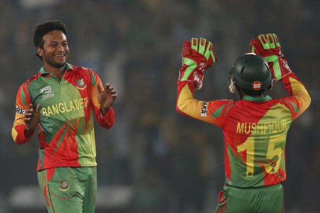 Bangladesh bowler Shakib Al Hasan, left, celebrates with captain Mushfiqur Rahim, right, the dismissal of West Indies' batsman Lendl Simmons during their ICC Twenty20 Cricket World Cup match in Dhaka, Bangladesh, Tuesday, March 25, 2014. (AP Photo/Aijaz Rahi)