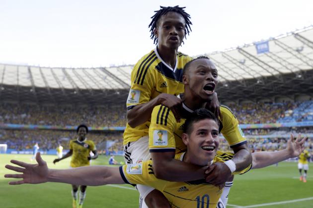 Colombia's James Rodriguez, bottom, is congratulated by his teammates after scoring his side's third goal during the group C World Cup soccer match between Colombia and Greece at the Mineirao Stadium in Belo Horizonte, Brazil, Saturday, June 14, 2014. Colombia defeated Greece 3-0. (AP Photo/Fernando Vergara)