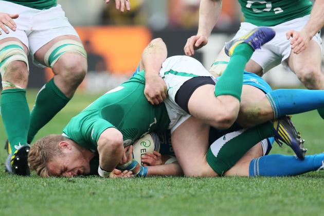 Ireland's Ian Madigan, is tackled by Italy's Leonardo Ghiraldini during a Six Nations rugby match between Italy and Ireland, at the Rome Olympic stadium, Saturday, March 16, 2013. (AP Photo/Paolo Giovannini)