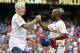 Philadelphia Phillies' Jimmy Rollins, right, celebrates his single with former Phillies' Mike Schmidt, left, during the fifth inning of a baseball game against the Chicago Cubs, Saturday, June 14, 2014, in Philadelphia. This single gives Jimmy Rollins the all time hits mark for the Philadelphia Phillies over Mike Schmidt. (AP Photo/Chris Szagola)