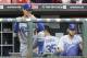Los Angeles Dodgers manager Don Mattingly (8) gives a sign from the dugout in the first inning of a baseball game against the Cincinnati Reds, Monday, June 9, 2014, in Cincinnati. (AP Photo/Al Behrman)