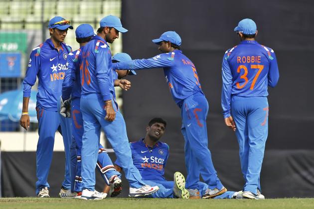 India's Umesh Yadav, sitting on ground, celebrates with his teammates the wicket of Bangladesh’s Ziaur Rahman during their first one-day International cricket match in Dhaka, Bangladesh, Sunday, June 15, 2014. (AP Photo/A.M. Ahad)
