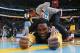 Denver Nuggets forward Kenneth Faried jokes with photographers while being stretched before facing the Utah Jazz in the first quarter of an NBA basketball game in Denver on Saturday, April 12, 2014. (AP Photo/David Zalubowski)