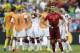 Portugal's Cristiano Ronaldo stands on the pitch as German players celebrate following Portugal's 4-0 loss to Germany during the group G World Cup soccer match between Germany and Portugal at the Arena Fonte Nova in Salvador, Brazil, Monday, June 16, 2014. (AP Photo/Natacha Pisarenko)