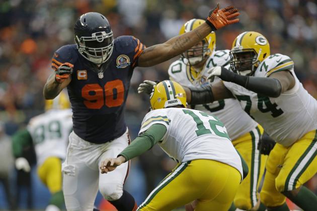 Chicago Bears defensive end Julius Peppers (90) rushes Green Bay Packers quarterback Aaron Rodgers (12) in the second half of an NFL football game in Chicago, Sunday, Dec. 16, 2012. (AP Photo/Nam Y. Huh)