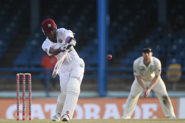 West Indies opening batsman Kraigg Brathwaite, left, hits a shot that is caught by New Zealand bowler Trent Boult for 129 runs during the second day of their second cricket Test match in Port of Spain, Trinidad, Tuesday, June 17, 2014. (AP Photo/Arnulfo Franco)