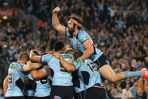 SYDNEY, AUSTRALIA - JUNE 18:  Aaron Woods (R) of the Blues jumps onto his team mates to celebrate a try by Trent Hodkinson during game two of the State of Origin series between the New South Wales Blues and the Queensland Maroons at ANZ Stadium on June 18, 2014 in Sydney, Australia.  (Photo by Mark Metcalfe/Getty Images)