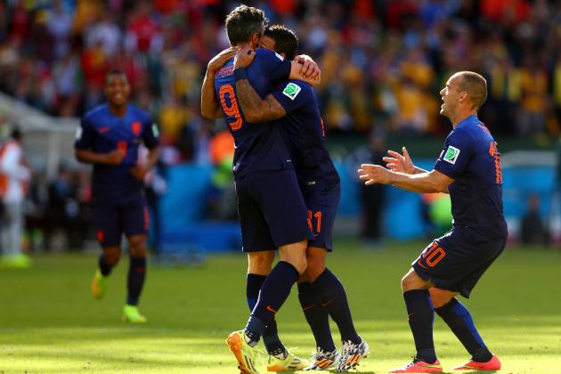 PORTO ALEGRE, BRAZIL - JUNE 18: Memphis Depay of the Netherlands (C) celebrates scoring his team's third goal with Robin van Persie (L) and Wesley Sneijder during the 2014 FIFA World Cup Brazil Group B match between Australia and Netherlands at Estadio Beira-Rio on June 18, 2014 in Porto Alegre, Brazil. (Photo by Quinn Rooney/Getty Images)