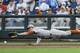 Texas first baseman Kacy Clemens (42) attempts to catch the ball hit for a single by UC Irvine's Kris Paulino in the second inning of an NCAA baseball College World Series elimination game in Omaha, Neb., Wednesday, June 18, 2014. (AP Photo/Eric Francis)