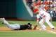 WASHINGTON, DC - MAY 28: Casey McGehee #9 of the Miami Marlins is picked off of first base in the eighth inning by Adam LaRoche #25 of the Washington Nationals at Nationals Park on May 28, 2014 in Washington, DC. Miami won the game 8-5 in ten innings. (Photo by Greg Fiume/Getty Images)