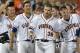 Virginia players celebrate with Mike Papi (38), who hit a double in the ninth inning against Mississippi that scored Thomas Woodruff to win an NCAA baseball College World Series game in Omaha, Neb., Sunday, June 15, 2014. Virginia won 2-1. (AP Photo/Ted Kirk)