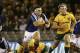 France's Guilhem Guirado, left, runs away from Australia's Michael Cooper, right, during their Rugby test match in Melbourne, Australia, Saturday, June 14, 2014. (AP Photo/Hamish Blair)