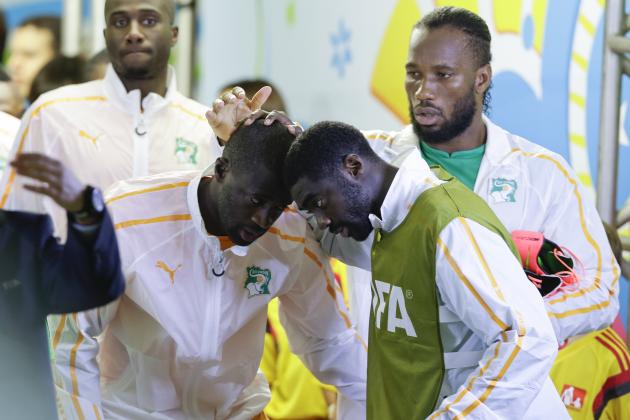 Ivory Coast's Kolo Toure and Yaya Toure, left, greet each other as Didier Drogba watches before the group C World Cup soccer match between Ivory Coast and Japan at the Arena Pernambuco in Recife, Brazil, Saturday, June 14, 2014. (AP Photo/Ricardo Mazalan)