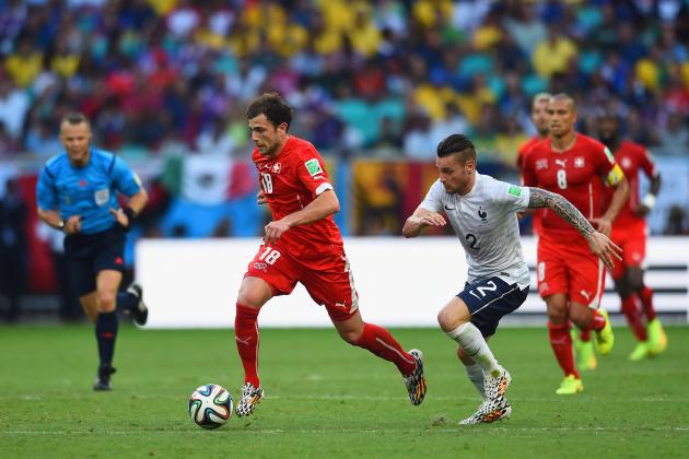 SALVADOR, BRAZIL - JUNE 20: Admir Mehmedi of Switzerland dribbles pas Mathieu Debuchy of France during the 2014 FIFA World Cup Brazil Group E match between Switzerland and France at Arena Fonte Nova on June 20, 2014 in Salvador, Brazil. (Photo by Christopher Lee/Getty Images)