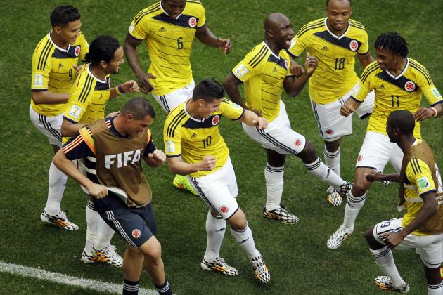 Colombia's James Rodriguez, center, dances with teammates in celebration after scoring during the group C World Cup soccer match between Colombia and Ivory Coast at the Estadio Nacional in Brasilia, Brazil, Thursday, June 19, 2014. (AP Photo/Themba Hadebe)