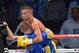 LAS VEGAS, NV - OCTOBER 12: Vasyl Lomachenko is lifted in the ring as he celebrates his fourth-round TKO victory over Jose Ramirez in their their featherweight bout at the Thomas & Mack Center on October 12, 2013 in Las Vegas, Nevada. (Photo by Ethan Miller/Getty Images)